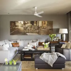 Elegantes salones en gris y madera oscura, con un gran sofá modular, mesa de centro y un cuadro de paisaje urbano.