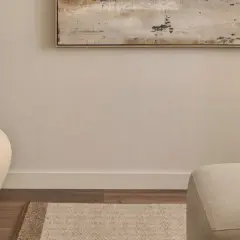 Ideas para decorar un pasillo: un jarrón grande y una alfombra geométrica bajo un cuadro abstracto.