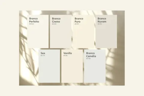 Muestras de pintura que ilustran la diferencia entre blanco y blanco roto, con nombres como "Branco Perfeito" y "Vanilla".