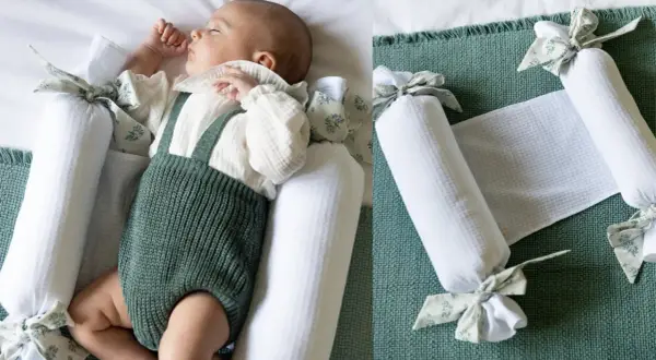 Bebé durmiendo plácidamente, rodeado de protectores para hacer colecho. Un nido seguro y acogedor.