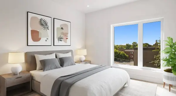 Dormitorio moderno con cama canapé vestida con ropa de cama blanca y gris, mesitas de noche y cuadros abstractos.