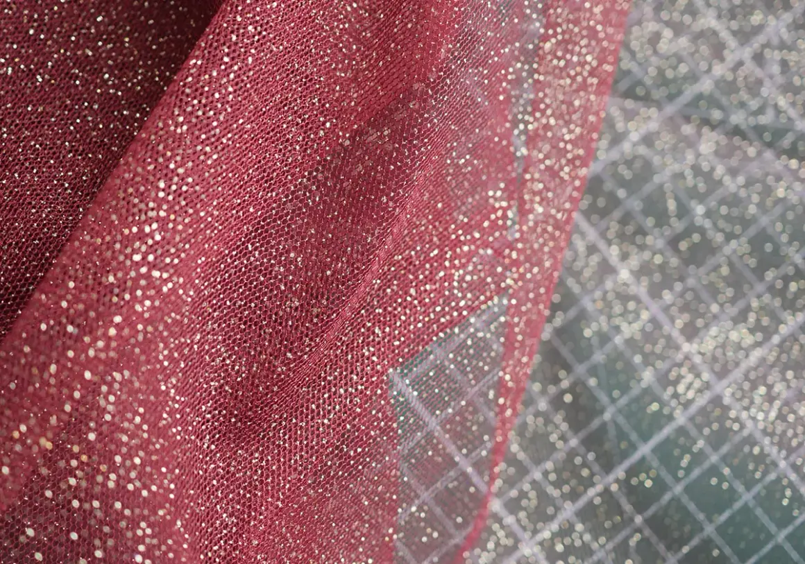 Tela de tul color vino con destellos dorados, ideal para disfraces o decoración festiva.