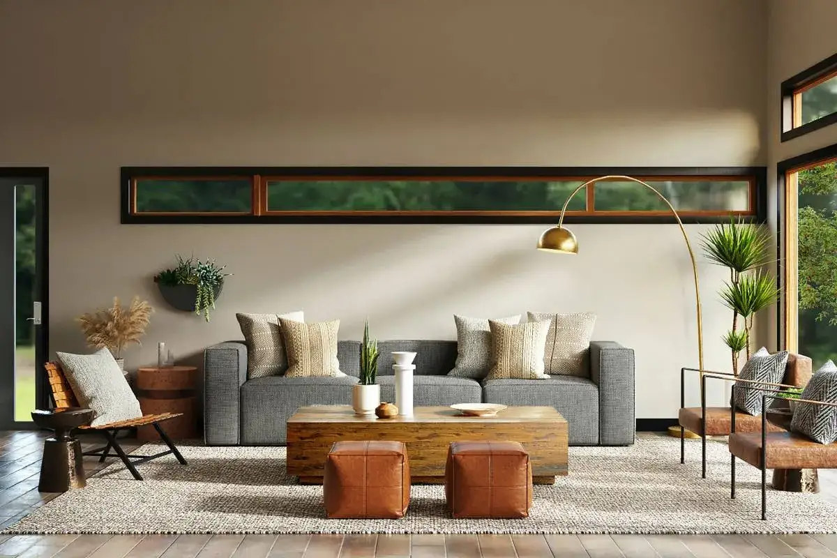 Sof&aacute; cheslong gris con cojines de diferentes texturas y colores, creando un ambiente acogedor.